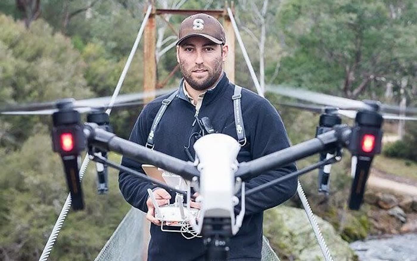 Shawn Peach on a suspension bridge with a drone
